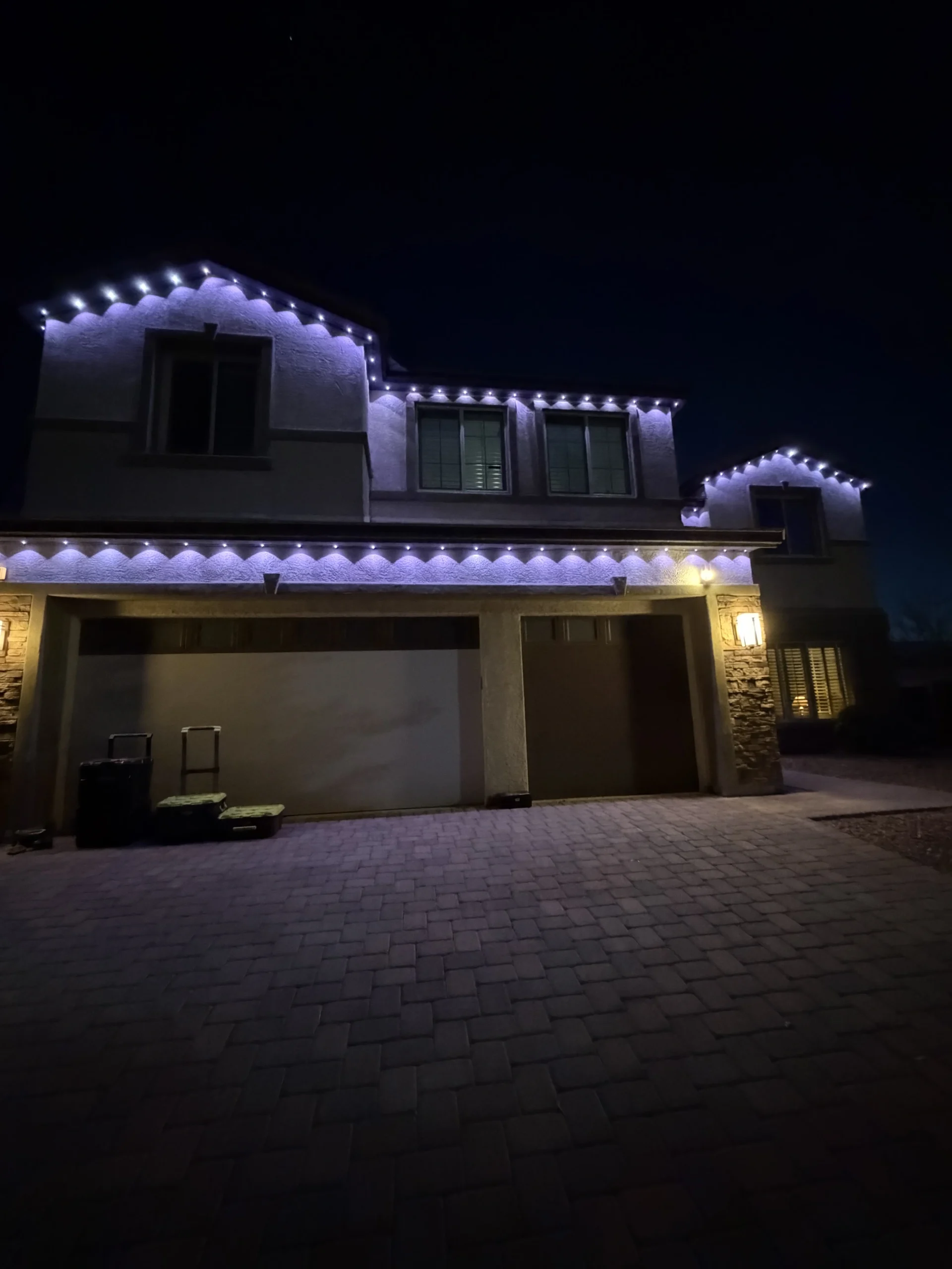 Hidden permanent lighting track installation on roofline