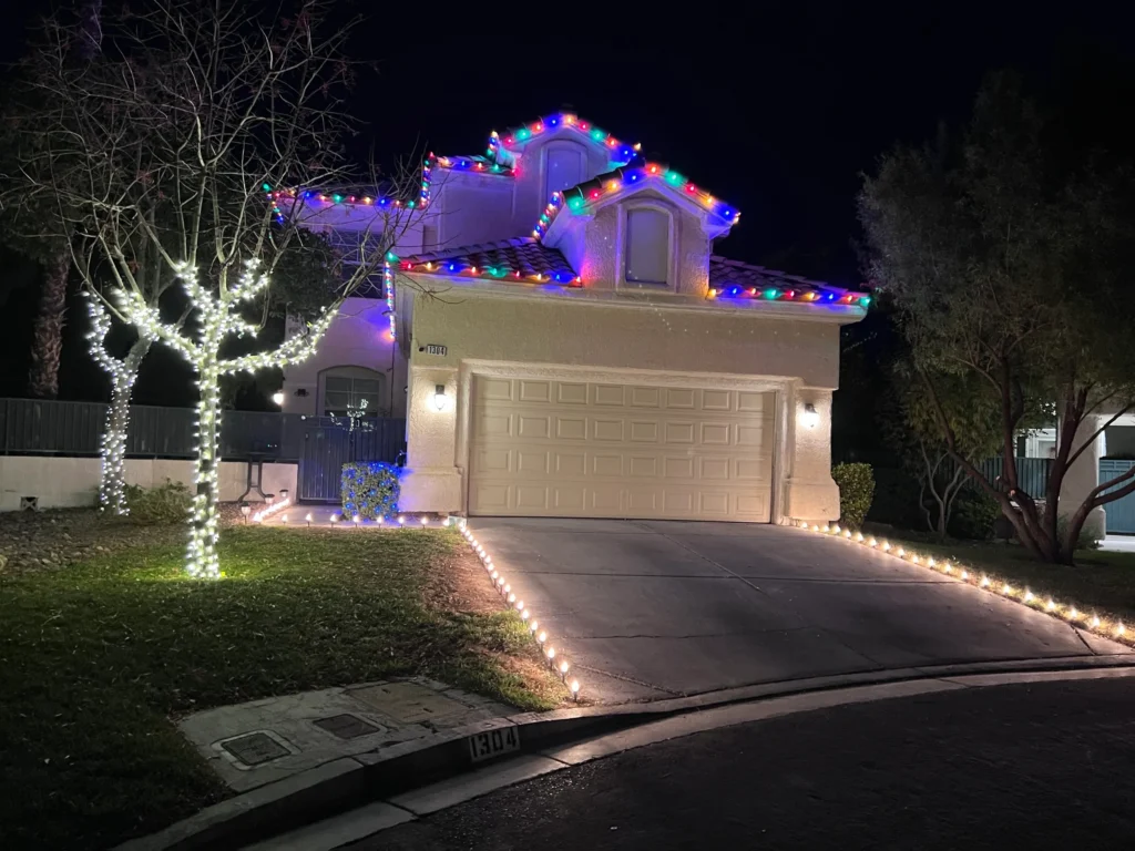 Christmas lights installed on a Summerlin home with the trees wrapped in Christmas lighting.