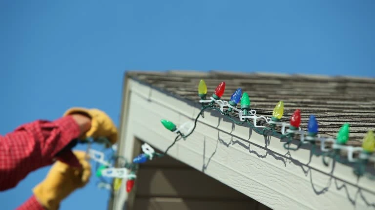 Person taking down Christmas lights